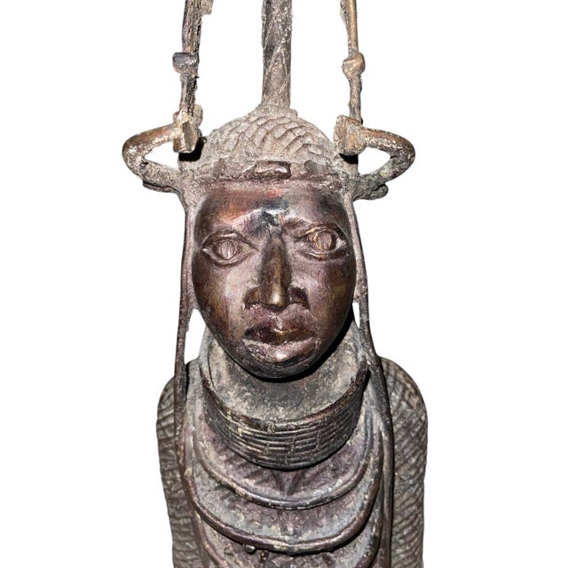 An early 20th century bronze head sculpture inspired by the revered Oba, the king and central authority of the historic...