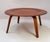 This iconic Eames table features a gently dished circular top in richly toned molded plywood. It is raised on four splayed...