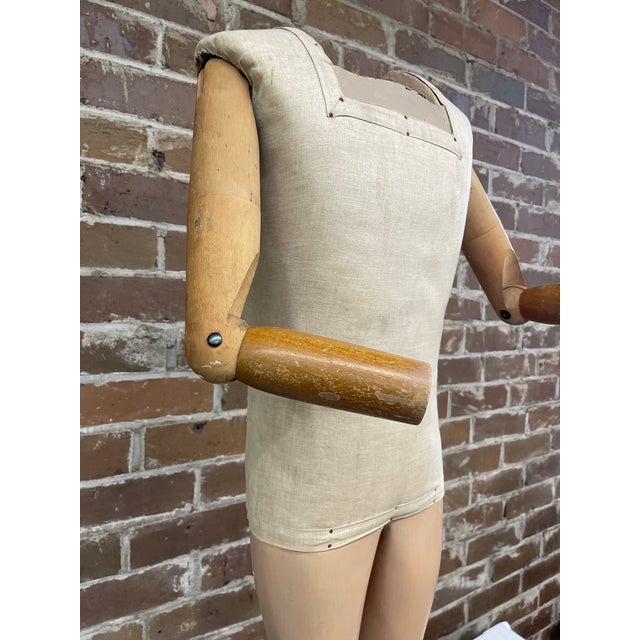 This fabric covered mannequin with articulated wooden limbs is characteristic of high quality Art Deco department store...