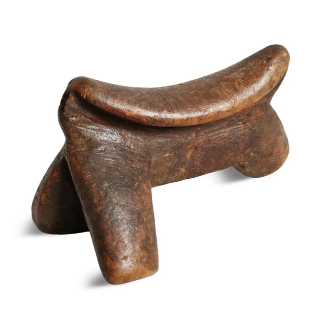 Old vintage East African headrest. These traditional personalized wood carved headrests were common utilitarian objects...