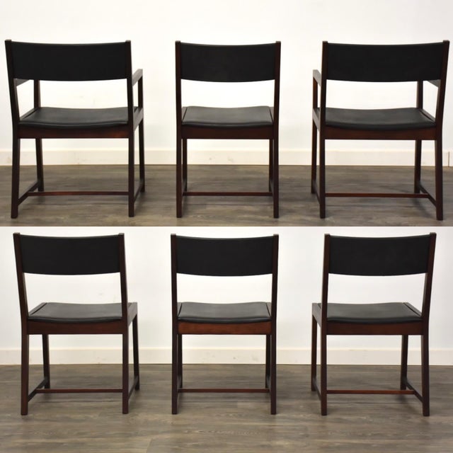 A set of 6 mid century modern walnut dining chairs with black vinyl upholstery designed by Milo Baughman for Directional...