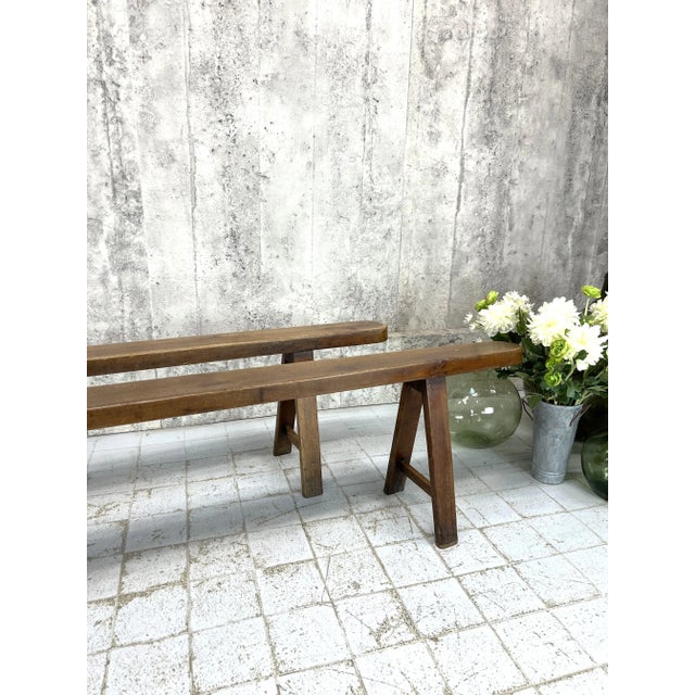 Dimensions: 218.5cm wide x 48cm high x 13.5cm deep. A rare and stunning pair of long, solid and heavy oak benches. These...