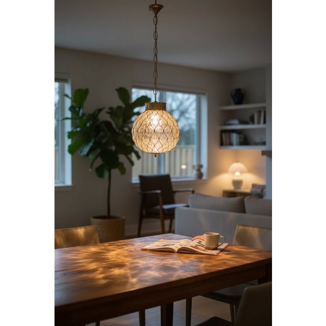 Murano Glass Brass Caged Pendant Light, Italy, 1960s This refined Italian pendant light from the 1960s features a hand-...