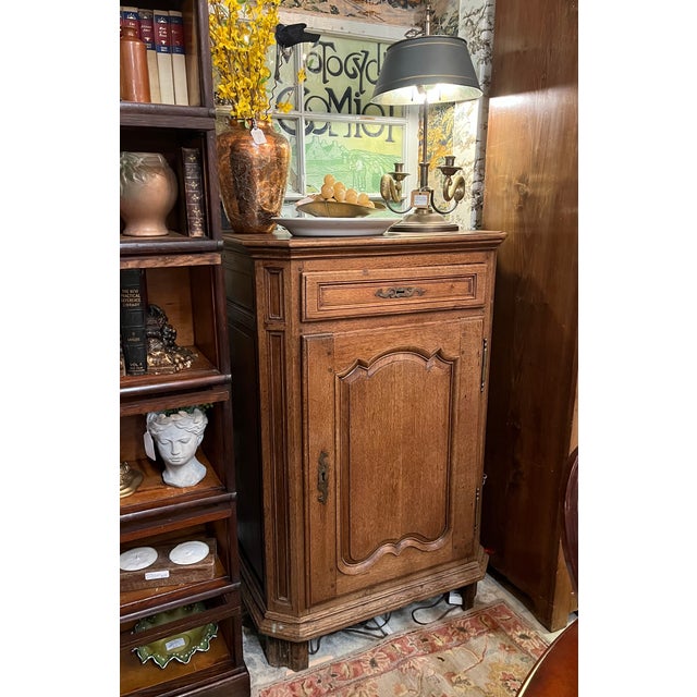 Imported from Belgium. Oak jelly cabinet. Louis XIV style with carved raised panel door.and corners. Single drawer and...