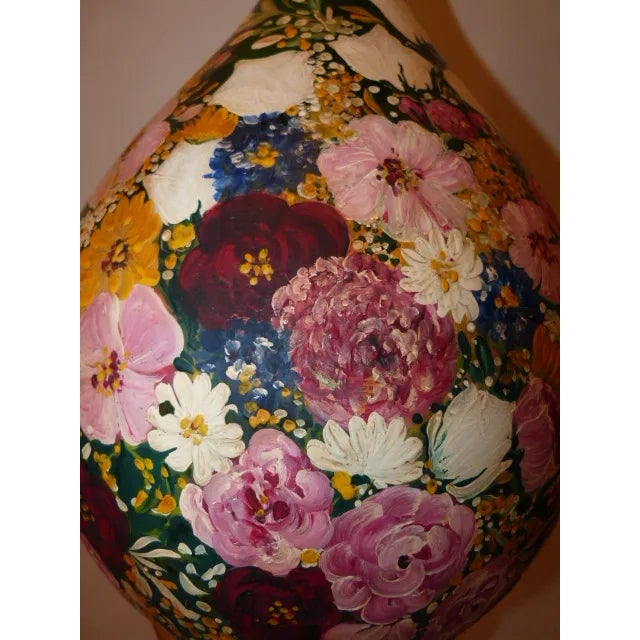 Hand painted green glass bottle with beautiful colorful flower design.