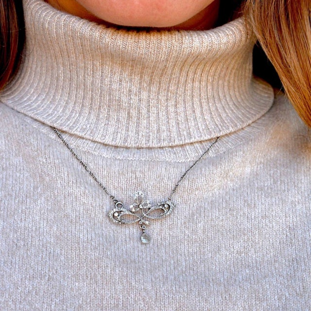 A stunning witness to the Art Nouveau era (circa 1910), this exquisite pendant is masterfully crafted in solid platinum....