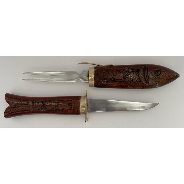 Hand carved wood and brass fish knife and serving fork carving set. Fish slides opens from center to reveal stainless...
