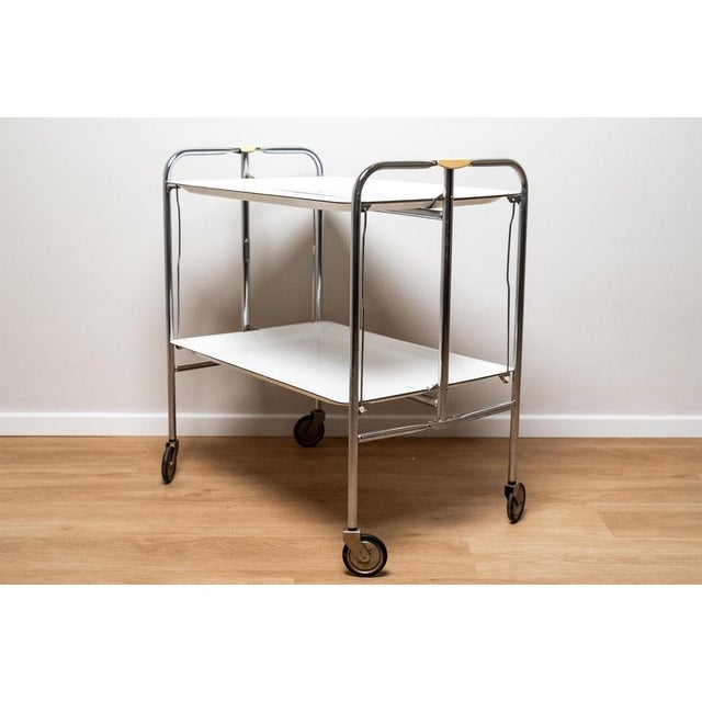 Plastic and chrome-plated metal bar or food cart, Made in Italy, 1970s. Particular folding bar or food cart made of white...