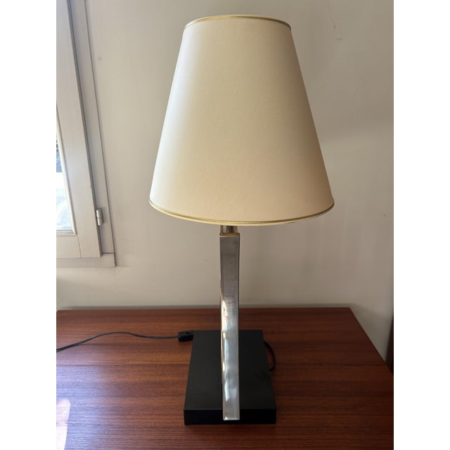Table lamp circa 1970, an iconic piece of the Hollywood Regency style. This exceptional light fixture features a...