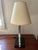 Table lamp circa 1970, an iconic piece of the Hollywood Regency style. This exceptional light fixture features a...