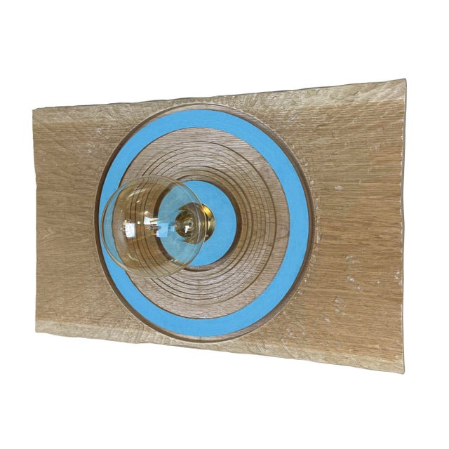 Light blue "Goccia" lamp by Pietro Meccani. Beautiful hand-carved oak wall lamp with colored parts. Designed in 1996, it...