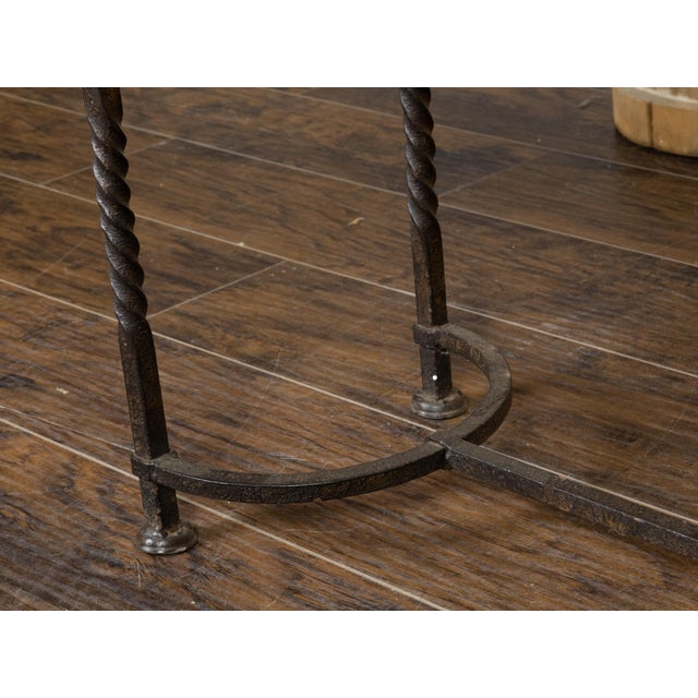 A vintage American Industrial style wood and metal shelving unit from the mid 20th century with two shelves, twisted...