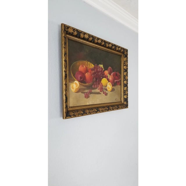 This is a gorgeous black and gold floral motif wooden frame original oil on canvas painting depicting a lovely arrangement...