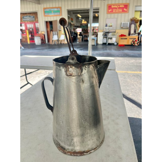 Early 20th Century metal pot with handle. Handmade welded steel metal. It has a wooden handle on a wrought iron bail...
