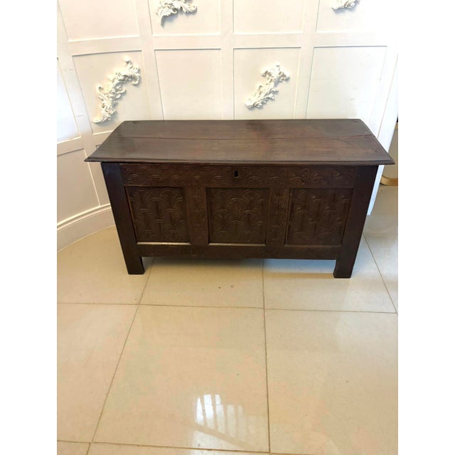 A superb antique oak coffer of excellent colour and presence, the front beautifully carved with repeating stylised foliate...