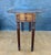 Spanish Neoclassical drop-leaf table crafted in oak, dating to the early 20th century. The table features a circular top...