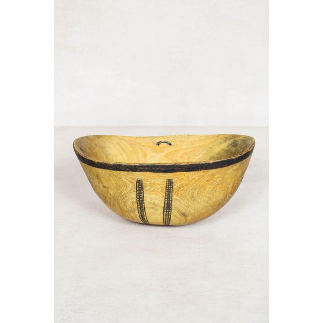 This hand-carved wooden bowl is made by the Turkana, a nomadic community in north-west Kenya prized for their woodcarving...