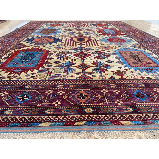 This vintage rug was hand-knotted in wool, woven in Afghanistan in the Kazak Caucasian tribal design tradition. Measuring...