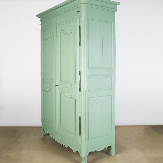 Elegant Soft Green Painted French Marriage Armoire from the 19th Century. Presenting a French Louis XV style painted...