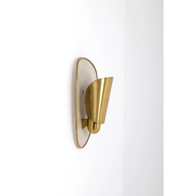 Rare wall lamp with perforated brass. Produced in Sweden by Ateljé Lyktan, 1950s. Up to 250V (Europe/UK Standard).The...