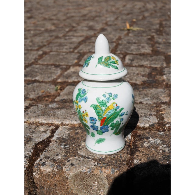 Ginger jar with floral and parrot decoration. Ginger jars are on trend and this one will blend in with classic, tropical,...