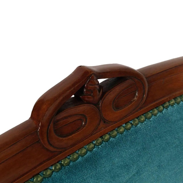 This is an elegant original Italian Art Nouveau armchair in solid walnut with new velvet upholstery. It is reminiscent of...