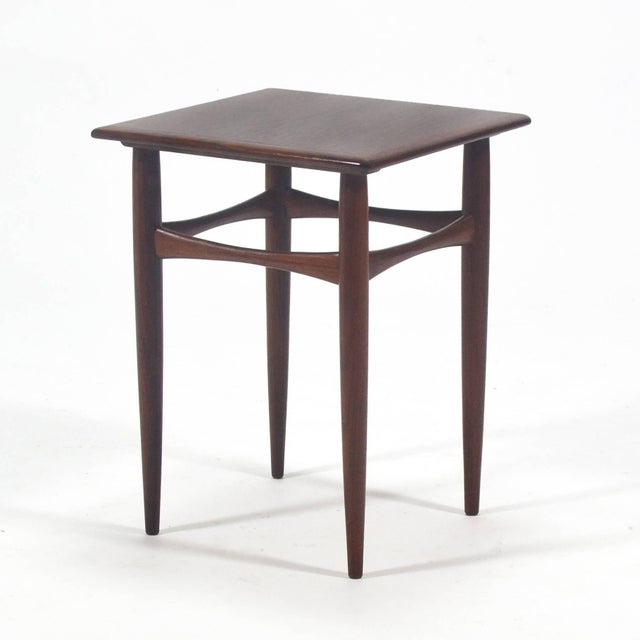 This delightful diminutive side table by Arne Hovmand-Olsen is crafted of rich rosewood and has subtle, beautiful lines...