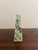 A beautifully proportioned marble obelisk in richly veined shades of yellow, cream, grey, and black. The sculptural...