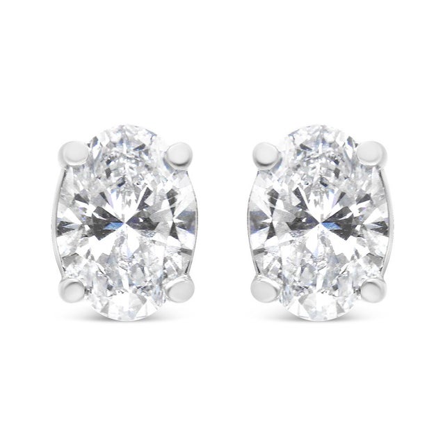 Add a touch of shine to your everyday look with these beautifully classic 1.00 cttw diamond solitaire earrings. These...
