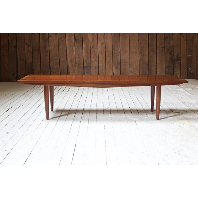 Long coffee table by Phillip Lloyd Powell with turned legs and solid figured cherry top. Rich patina in the cherry boards;...