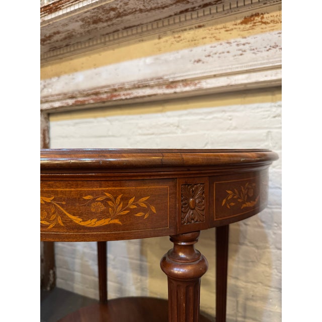 This is an antique mahogany inlay round side table. It has satin banding. It is in the Sheraton style. It is absolutely...