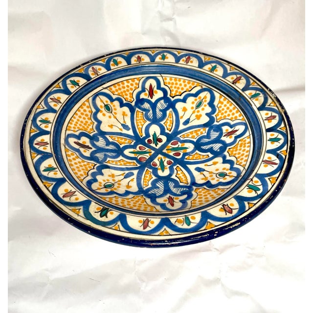 Stunning antique Moroccan bowl with blue, yellow, and terracotta moorish design from the late 19th century. The piece has...