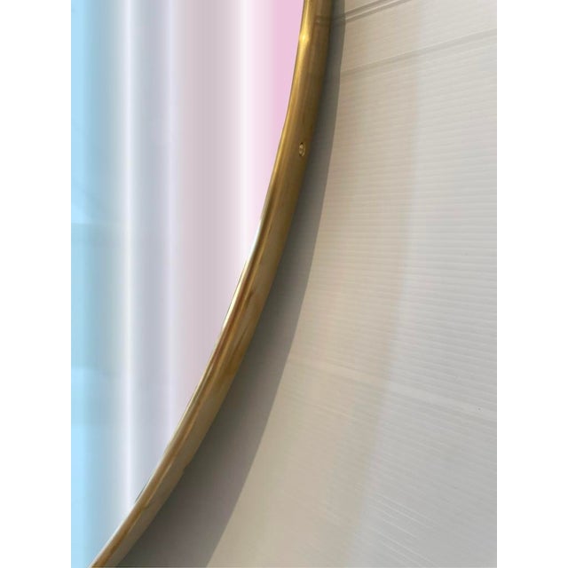 Elegant vintage mirror with an all-brass frame and wooden back. It features a convenient steel hook to ensure stability on...