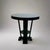 Art Deco style Gueridon. Black lacquer finish on four legs with center shelf. Late 20th Century. Feet are finished with...