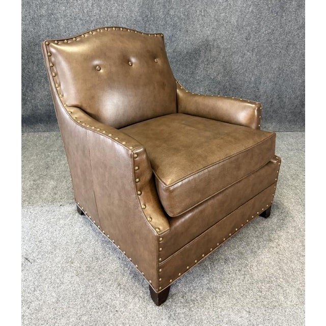 This new showroom sample Alden Parks modern leather club chair is upholstered in rich brown leather with button tufting...