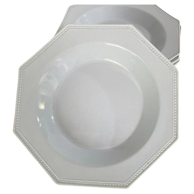 This set of octagonal pearl-glazed creamware dishes was made in France in the early 19th century. The dishes have a...