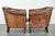 This set of 2 sturdy vintage sheepskin club armchairs has a cool look and a comfortable seat. They feature loose seat...