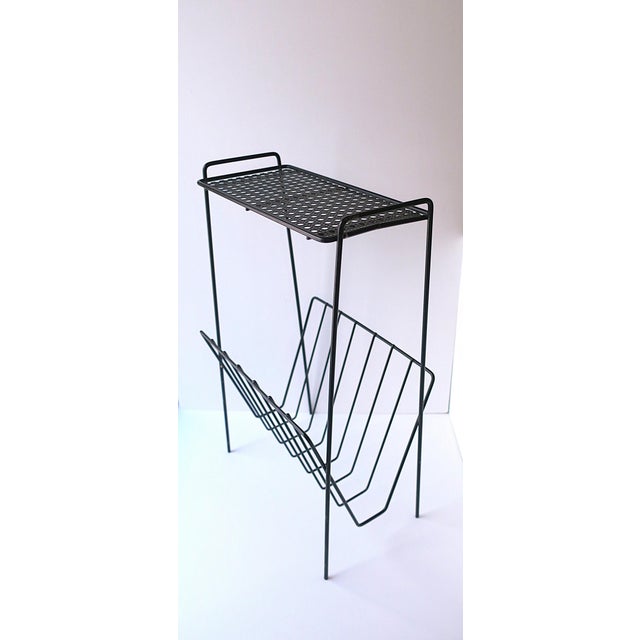A rectangular black metal side drinks table with perforated top and bottom rack, Midcentury Modern design, circa mid-20th...