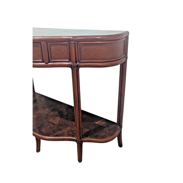 This beautiful 20th Century British Colonia style console table with a single centered drawer and four tapered legs that...