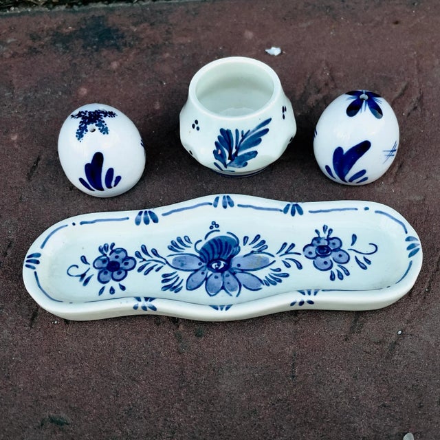 Hand painted Delft ceramic condiment set , S& P shakers and a small condiment serving bowl with a matching tray. From a...