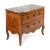 An elegant Louis XVI period commode dating to the late 18th century, crafted in richly figured walnut and retaining a...