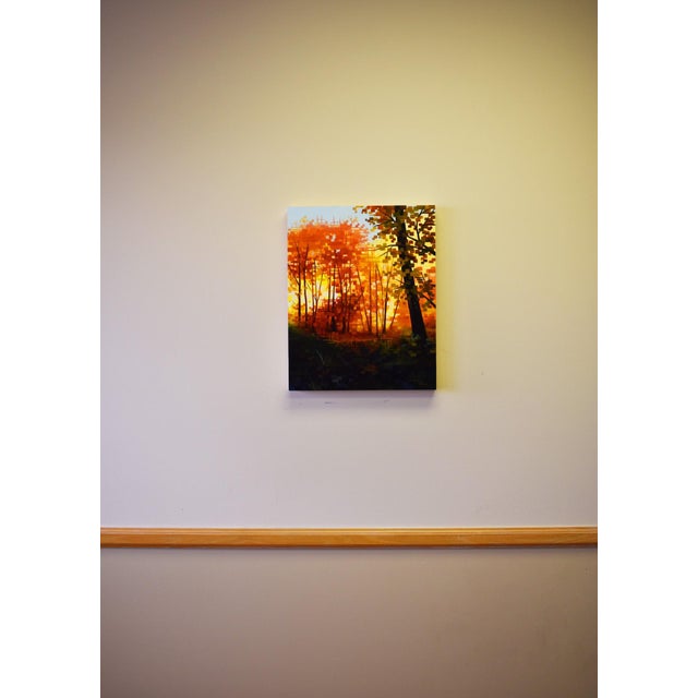 The artwork features a vibrant grove bathed in warm hues of orange and yellow, evoking the feeling of a sunlit autumn day....