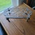 This antique solid brass kettle stand trivet, also known as a plant pot riser, is a handmade piece originating from...