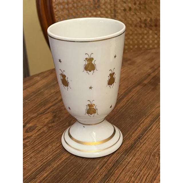 Empire porcelain vase with gilt motifs, bees and wreath, typical of that period. This piece has an attribution mark, I am...