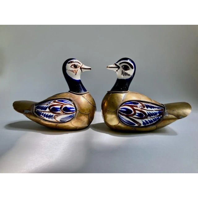 Two small Tonala, Mexico hand painted Glazed Ceramic and Brass Ducks. Featuring Brass body and tail feathers, hand applied...