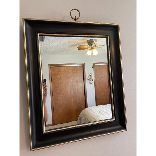 A striking Mid Century Modern wood framed wall mirror from the "Fashion Plate" line of the Turner Manufacturing Company....
