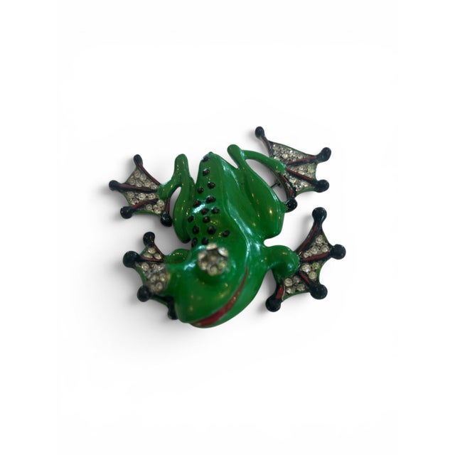 A fun piece of history in this bright green enamel smiling frog brooch with rhinestone eyes & webbed feet accented in...