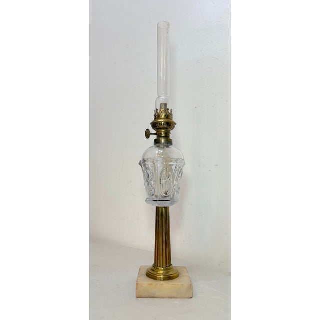 Up for sale is a lovely antique 19th century oil lamp made of glass, brass, and marble accents. This lamp is perfect for...