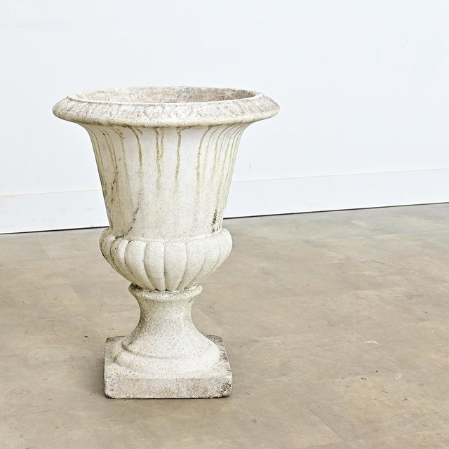 This single garden urn from the early 1900s is made of reconstructed stone. The campana silhouette planter has a unique...