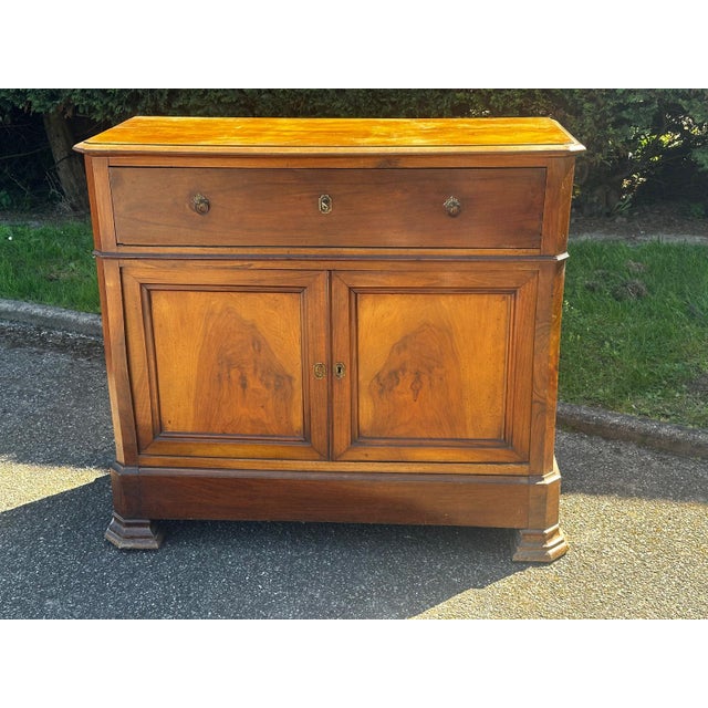 Louis-Philippe period drop-front secretary desk/commode in walnut with beautiful flame grain. This piece combines...
